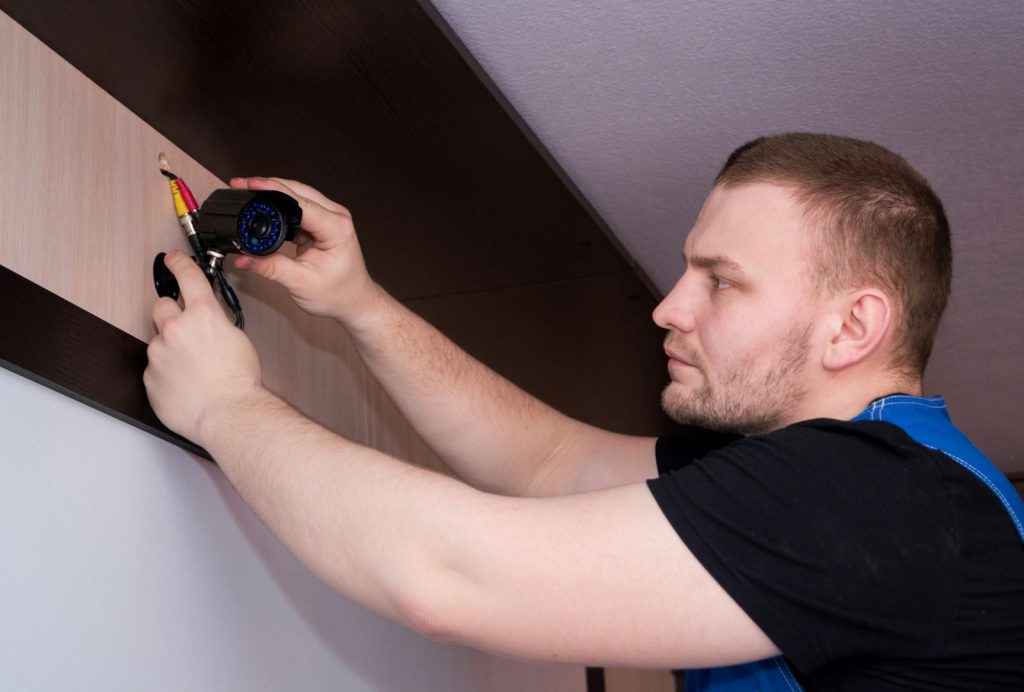 a man working on a wall with a screwdriver, vaktmester priser