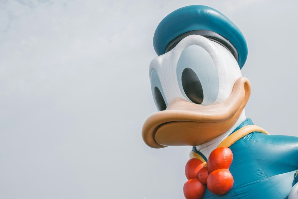 a large mickey mouse balloon with a bow tie, disney+