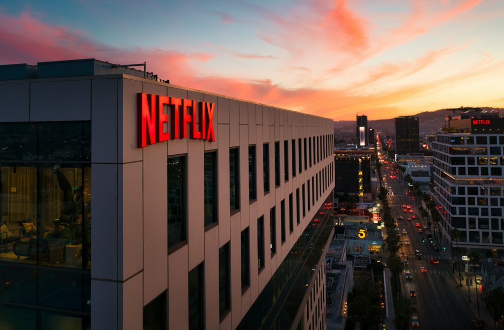 white and black concrete building during night time, priser på netflix