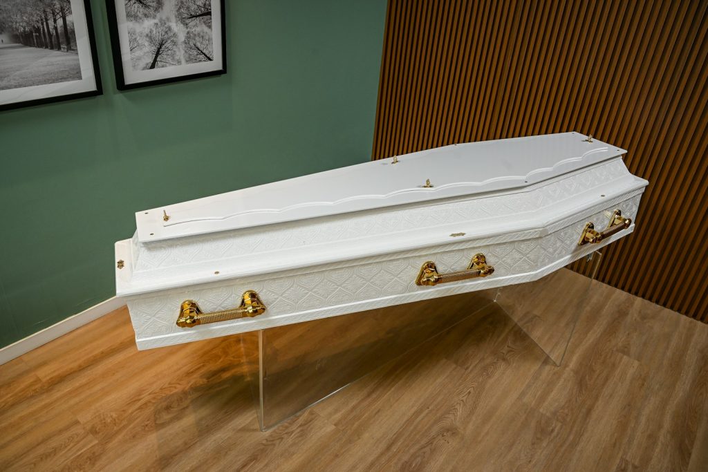 A white piece of furniture sitting on top of a hard wood floor